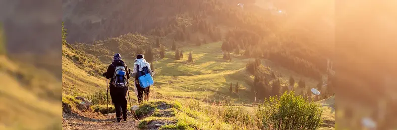 Two people walking the Inca Trail at sunset.