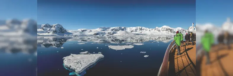 Guests on the Water's Edge Observation Deck on an Atlas Ocean Voyages expedition voyage, overlooking glacial landscapes.