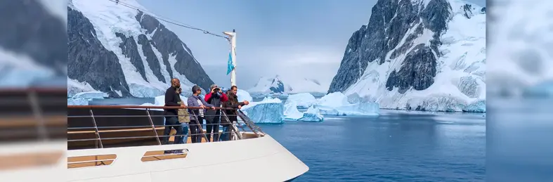 Guests aboard an Atlas Ocean Voyages cruise on the Water's Edge Observation Deck.