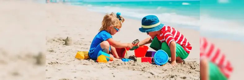 Kids playing in the sand on the beach