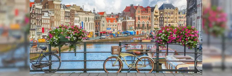 Two bicycles on a bridge over a canal in Amsterdam, the Netherlands' capital.