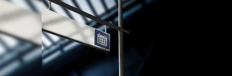 A sign at an airport with an icon of a Calendar on it.