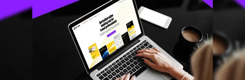 A travel agent exploring the RateHawk website on an Apple Macbook.