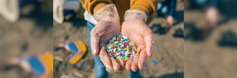 A volunteer holding the rubbish they have collected from a beach clean 