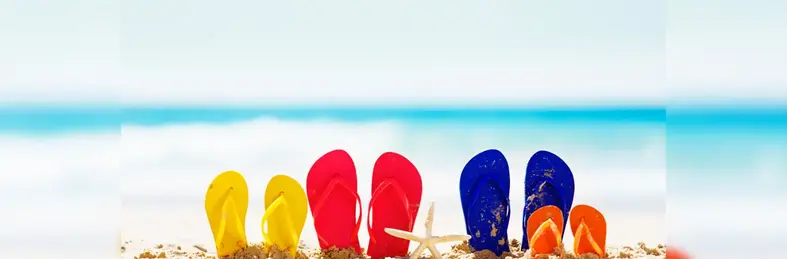 Image of a family's sandals sticking up in the sand