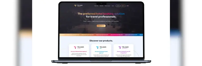 An Apple laptop open on the home page of Teldar Travel's website.