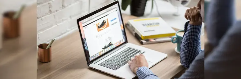 A person exploring car hire quotes on a laptop.