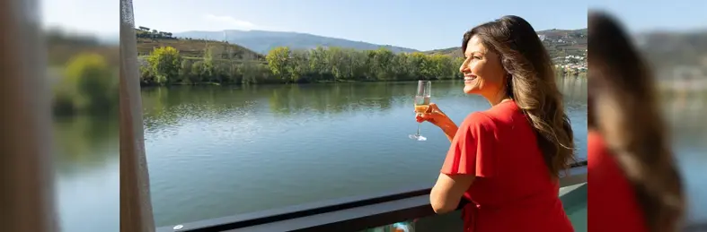 Lady drinking wine on the deck of a river ship