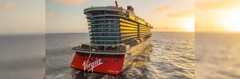Image of the Scarlet Lady vessel sailing into the sunset