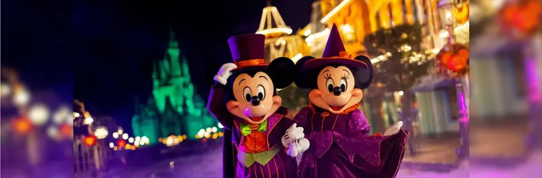 Mickey and Minnie in Halloween costumes on Main Street, USA at Walt Disney World in Florida.