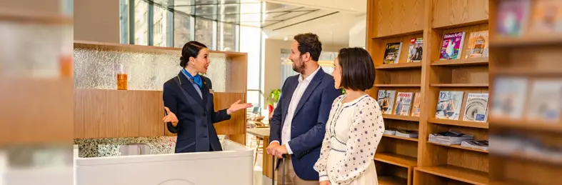 Two guests and a concierge at Eurostar's recently-renovated Premier lounge in Brussels.