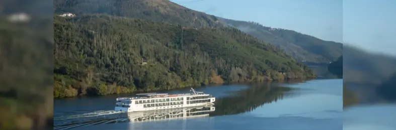 A river cruise ship sailing down the Douro River.