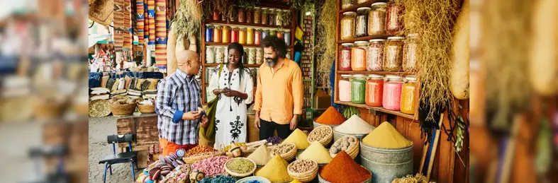 Travellers gathering in a Moroccan spice stall