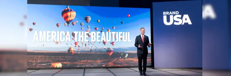 Fred Dixon, president and CEO of Brand USA, on stage at IPW 2025 in Chicago.