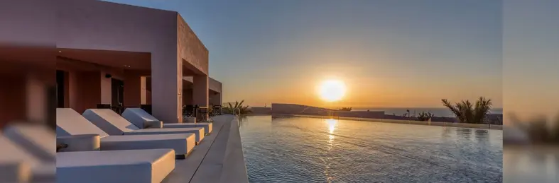 The communal pool area at Domes Novos Santorini, an Autograph Collection hotel on the Greek island of Santorini.