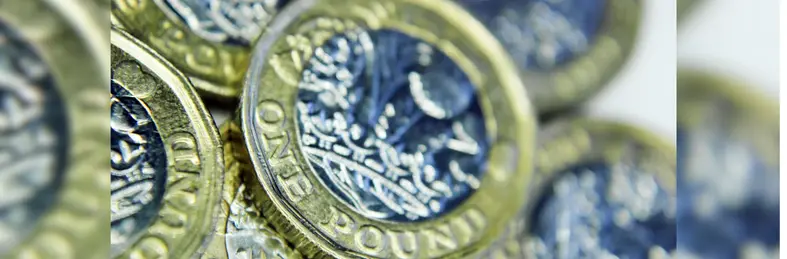 A pile of British £1 coins.