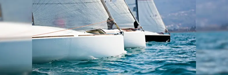Sail boats in a line in the sea