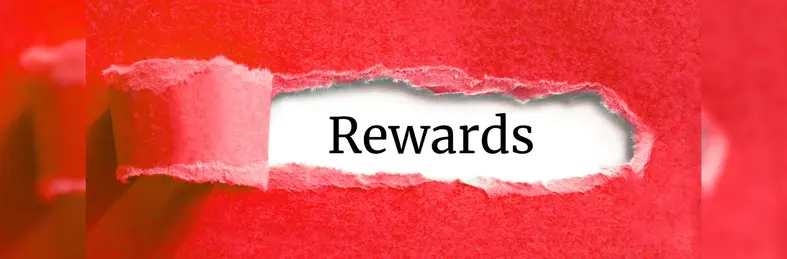 A tear in a piece of red paper revealing the word 'Rewards'