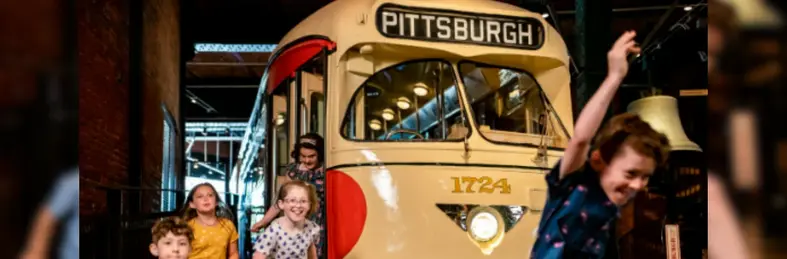 Children playing on a vintage bus at Pittsburgh's Heinz History Center.
