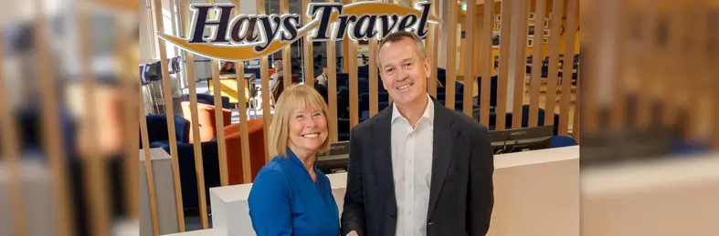 Dame Irene Hays shaking hands with Chris Gardner at the Hays Travel headquarters in Sunderland.