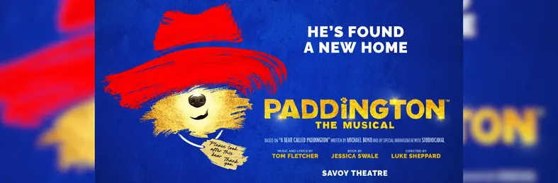 A promotional banner for the upcoming 'Paddington: The Musical' at the Savoy Theatre in London.