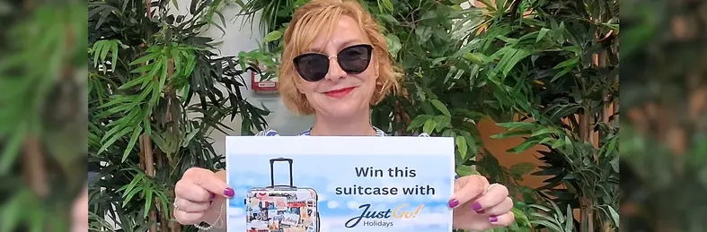 Claire Dutton, trade sales manager at the JG Travel Group, posing with a promotional flyer for Just Go! Holidays' new campaign.
