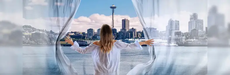 Lady gazing out to the Seattle skyline opening curtains