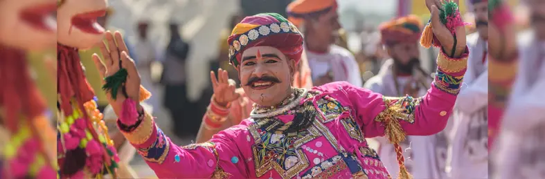 A person in traditional Indian dress celebrating at the Kite Festival in Uttarayan, India.