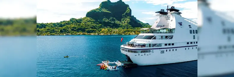 Windstar ship with guests in the water behind it