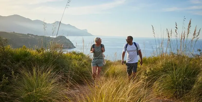 Two people hiking on a scenic coastal trail