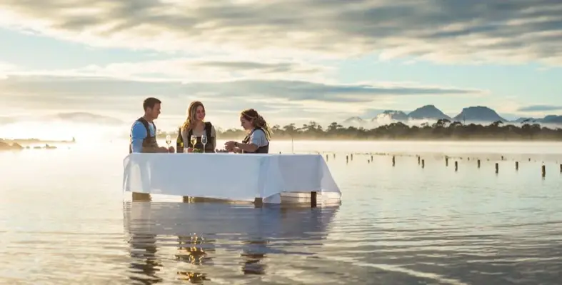 Three people at a marine farm experience at Tasmania's Saffire Freycinet all-inclusive resort.