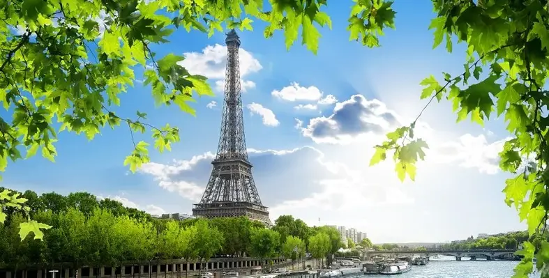 The Eiffel Tower, photographed from across the Seine River.