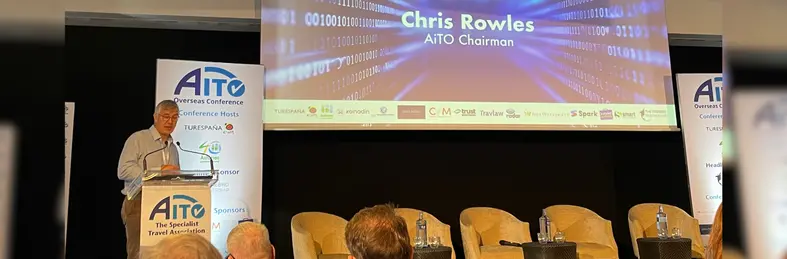Chris Rowles, AITO chairman, on stage at the association's 2025 conference in Asturias, Spain.