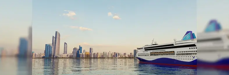 Celestyal Discovery sailing in the Arabian Gulf with Abu Dhabi on the horizon.