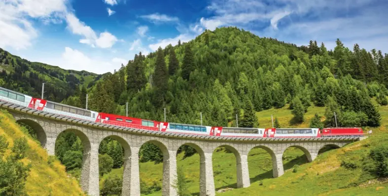 The Bernina Express train crossing the Landwasser Viaduct in the Swiss Alps. 