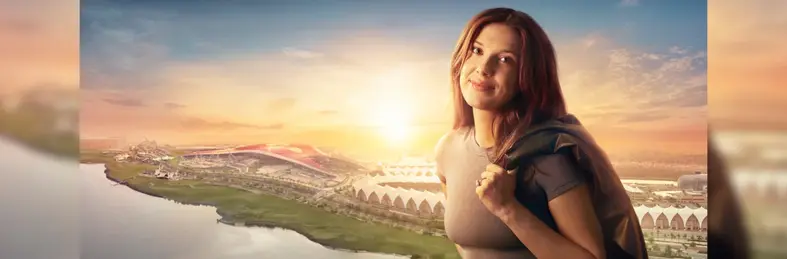 Millie Bobby Brown in front of an image of the Yas Island skyline.