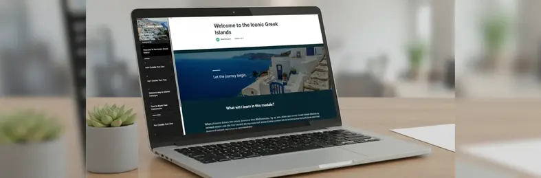 A Macbook on a wooden desk, open on the Greek Islands e-learning module on Celestyal's trade education platform.