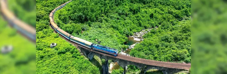 The Blue Jasmine train journeying across a viaduct in Thailand.