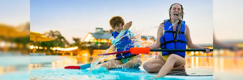 Two people on a paddleboard at Evermore Orlando Resort.