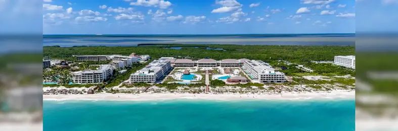 Ocean Allure Costa Mujeres in Mexico, a large white resort with the blue ocean in front