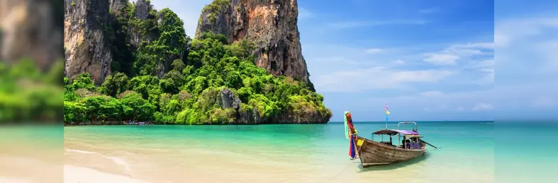 Thai traditional wooden longtail boat and beautiful sand beach in Thailand.
