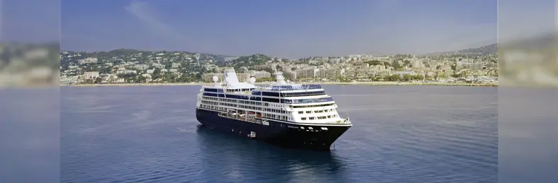Azamara Quest, docked near a coastal city.