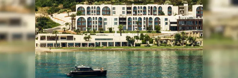 Domes Miramare on the beachfront with a private speedboat in the shot