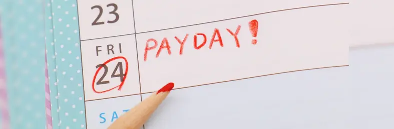 A calendar with Friday 24th circled and the word 'PAYDAY!' written on it.