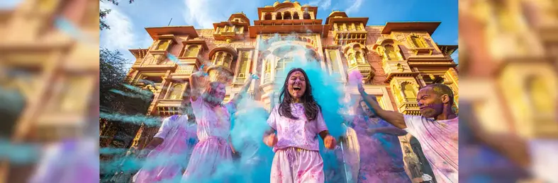 A lady covered in paint during a celebration