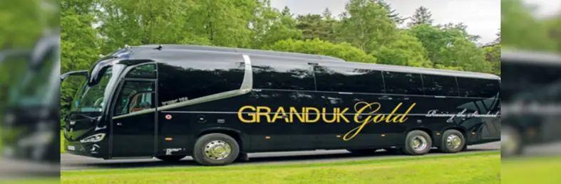 A black 'Grand UK Gold' branded coach.