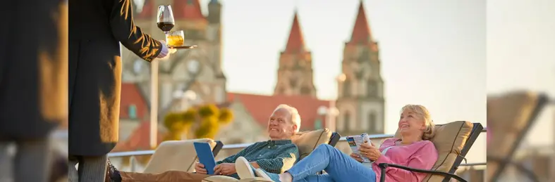 Two people on the sundeck of the SS Maria Theresa, a Uniworld-operated river cruise ship.