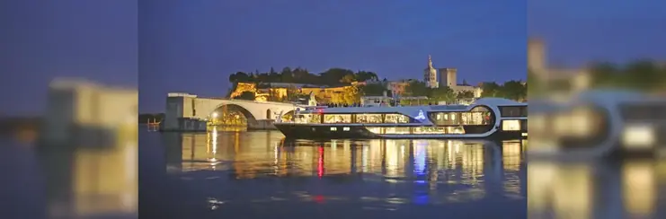 Avalon cruise ship docked at port during the night. 