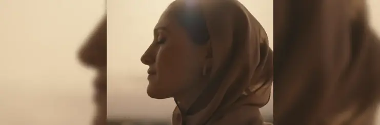 A cinematic shot of a women in the 'Our Flame' campaign cinematic