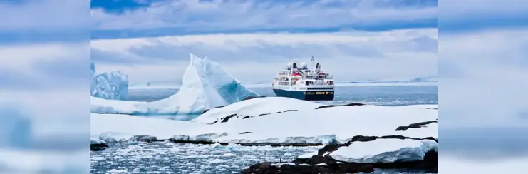 Cruise ship sailing past icebergs 